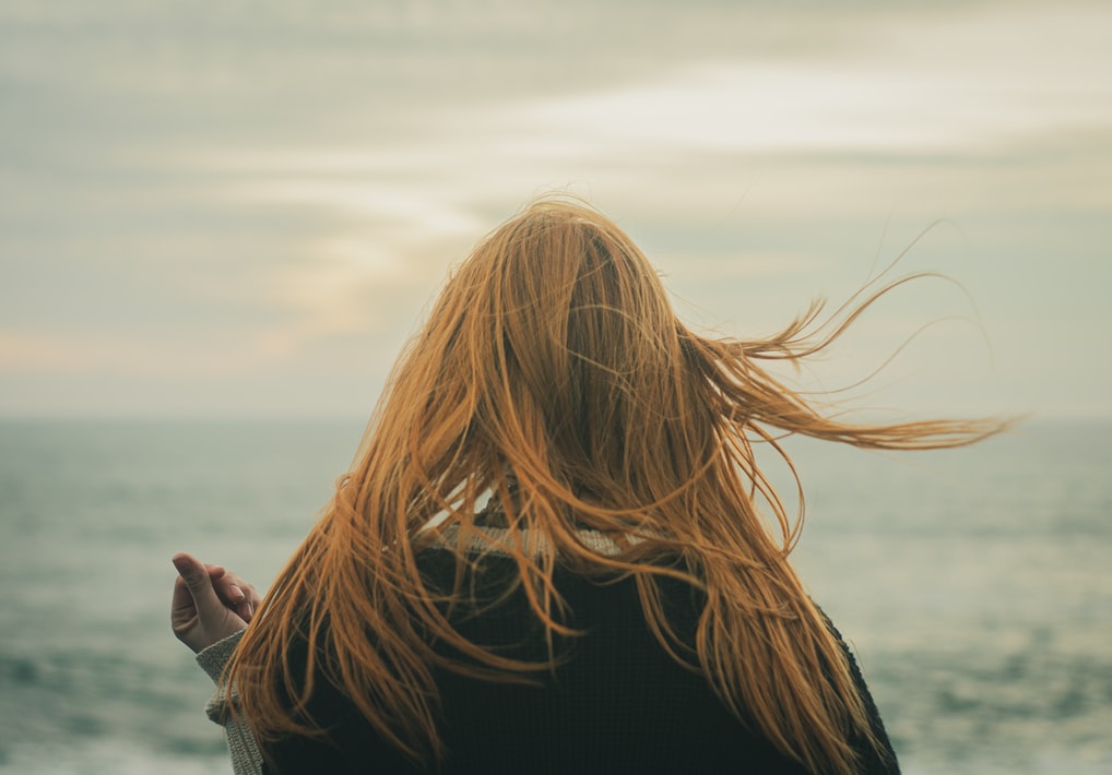 woman looking away into the ocean