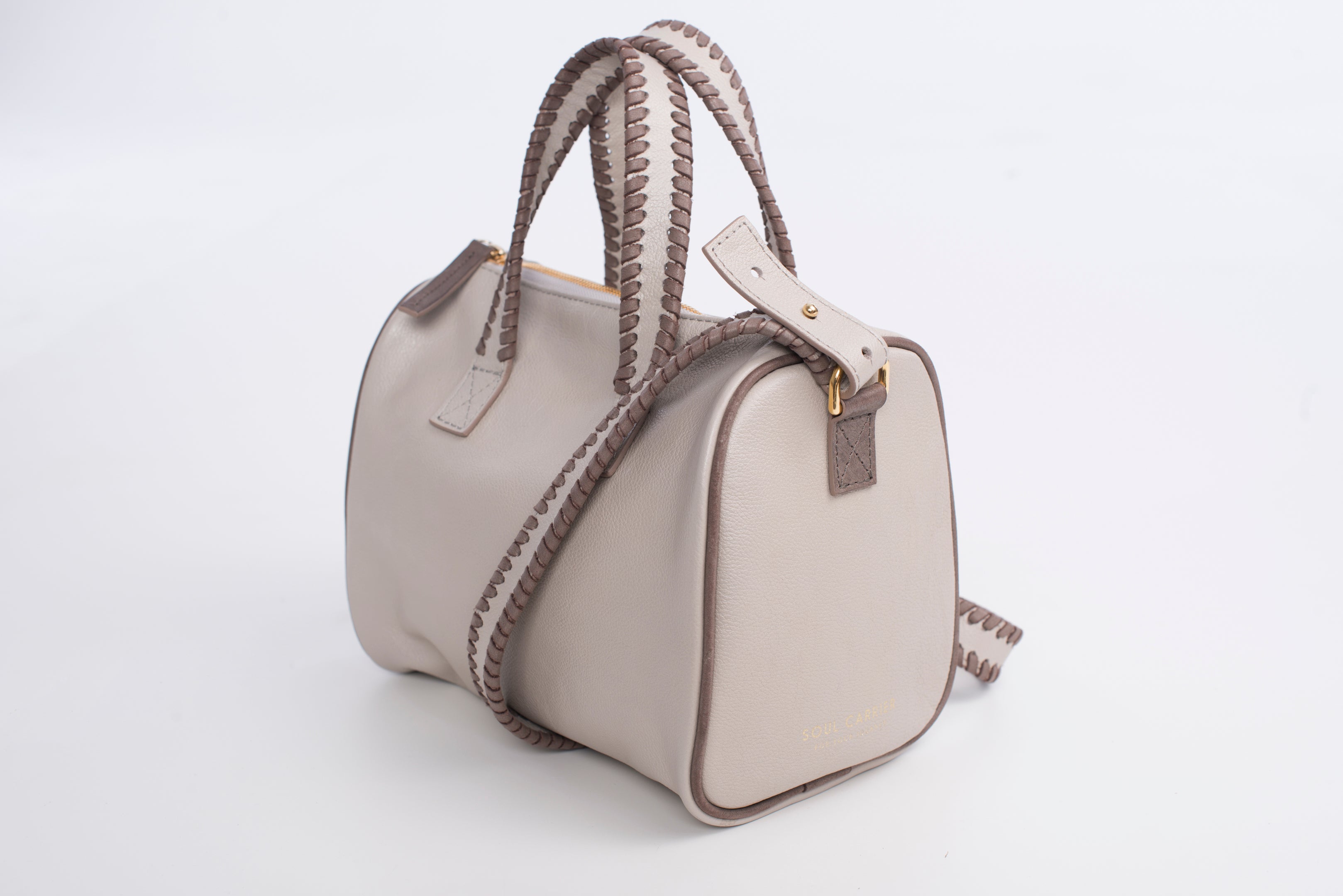 3 quarters view of true north satchel. Features detachable strap with side Metal D Rings