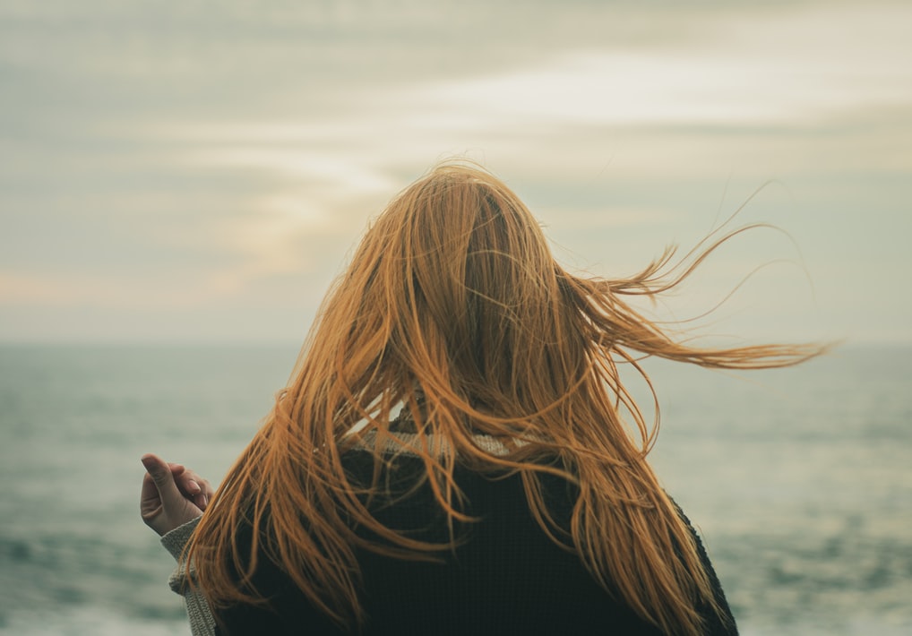 woman looking away into the ocean 